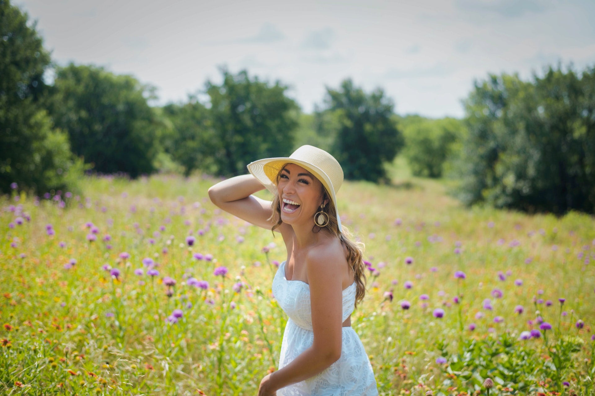 Woman in white dress with bright smile